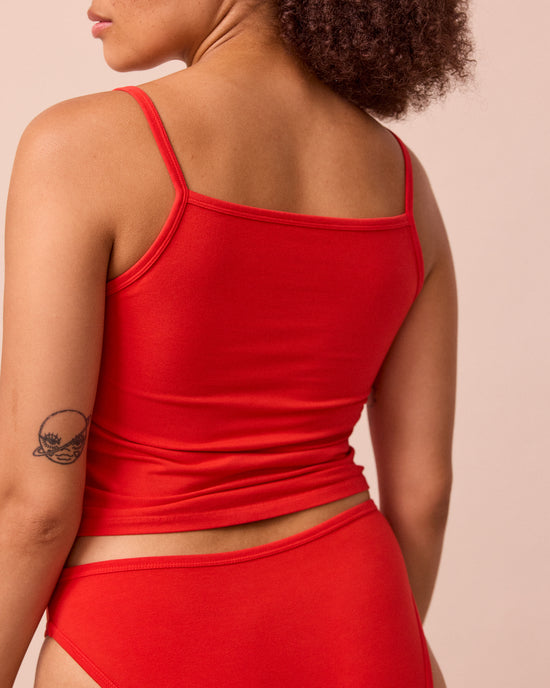 model wears tomato red jersey vest