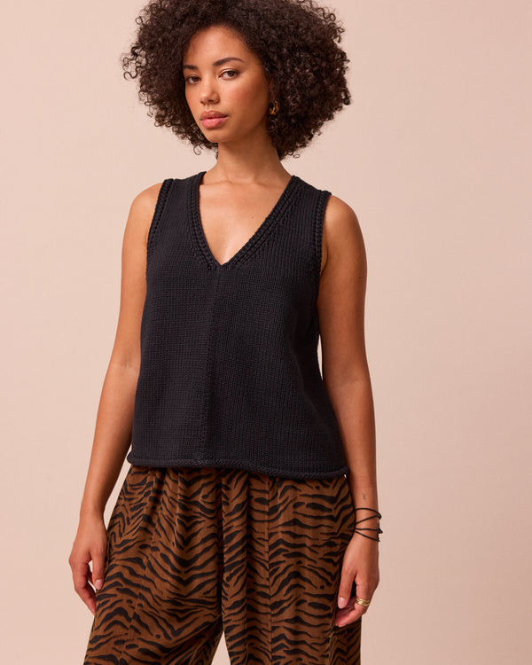 model wears vita black knitted vest