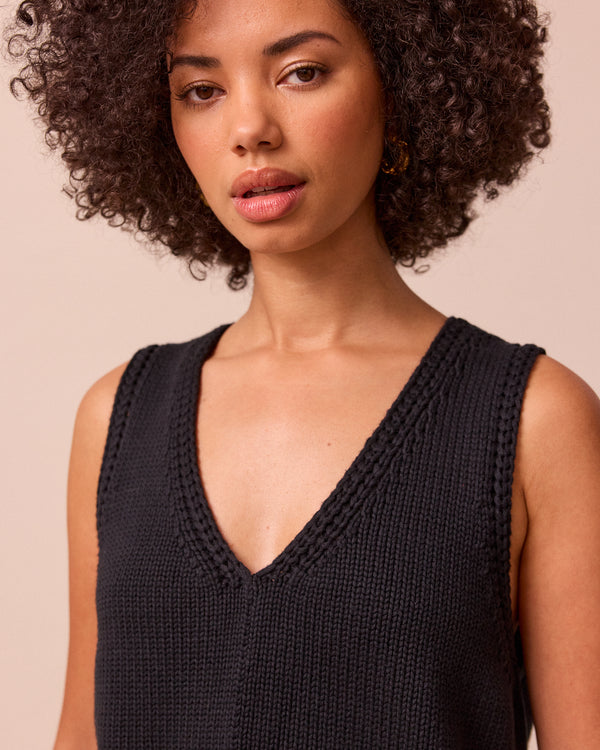 model wears vita black knitted vest