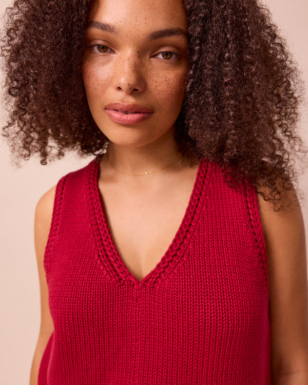 model wears vita cranberry knitted vest