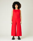 pregnant model wears red linen vivienne jumpsuit