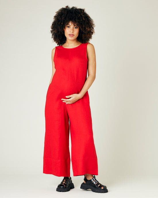 pregnant model wears red linen vivienne jumpsuit