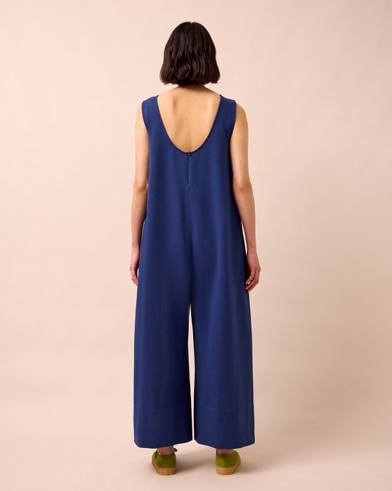 model wears vivienne french navy jersey jumpsuit
