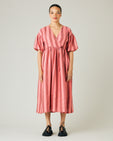 model wears blush stripe linen winnie dress