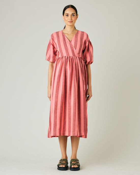 pregnant model wears blush stripe linen winnie dress