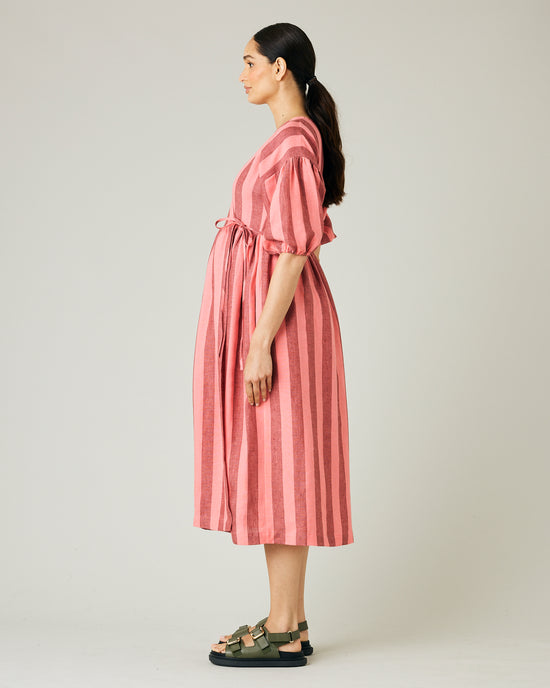 pregnant model wears blush stripe linen winnie dress