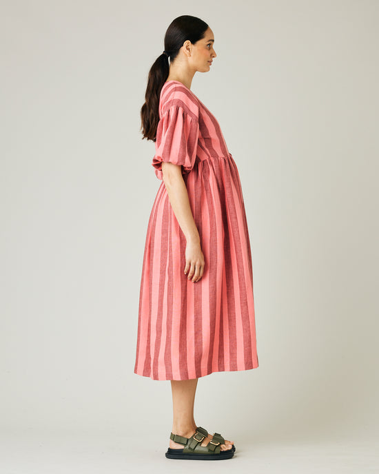 pregnant model wears blush stripe linen winnie dress