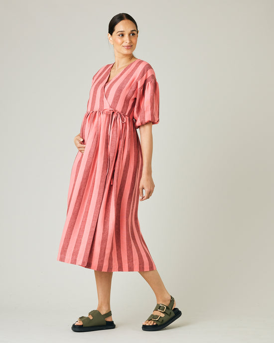 pregnant model wears blush stripe linen winnie dress