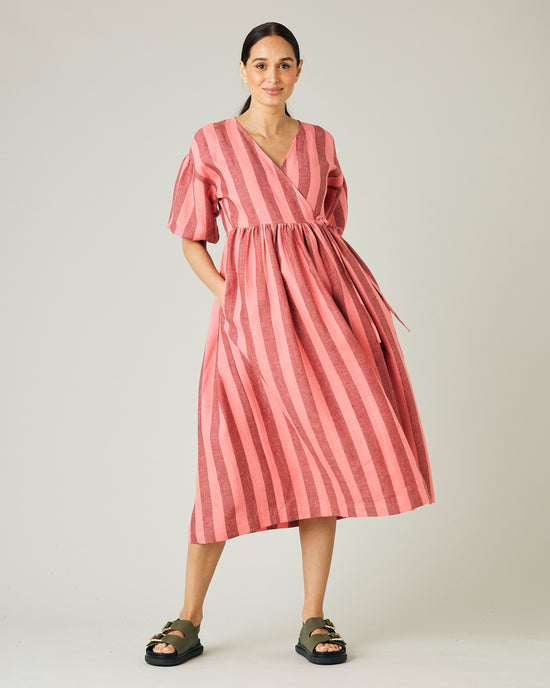 pregnant model wears blush stripe linen winnie dress