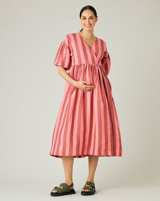 pregnant model wears blush stripe linen winnie dress