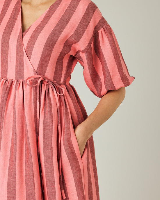 pregnant model wears blush stripe linen winnie dress