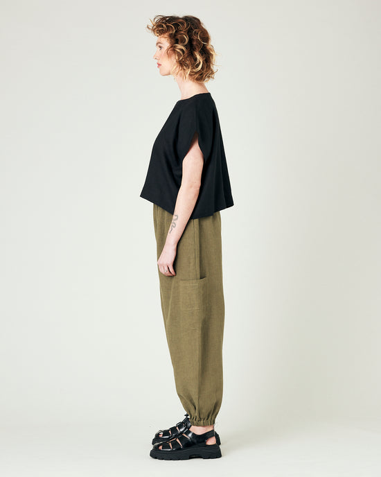 model wears light khaki linen yoli trousers