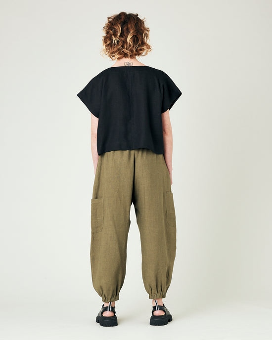 model wears light khaki linen yoli trousers