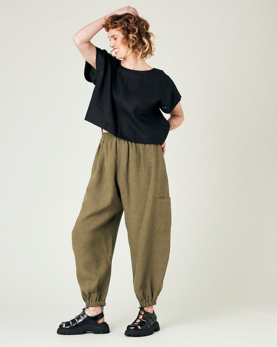 model wears light khaki linen yoli trousers