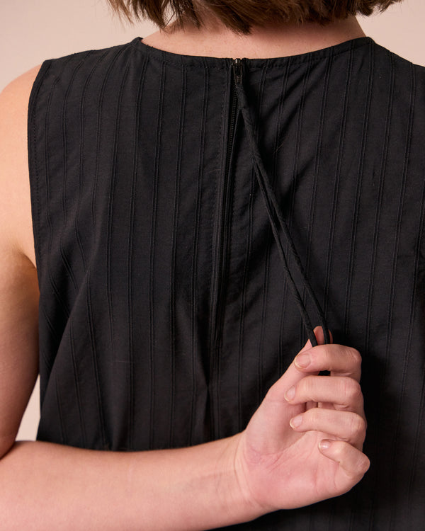 model wears zena black self stripe cotton dress