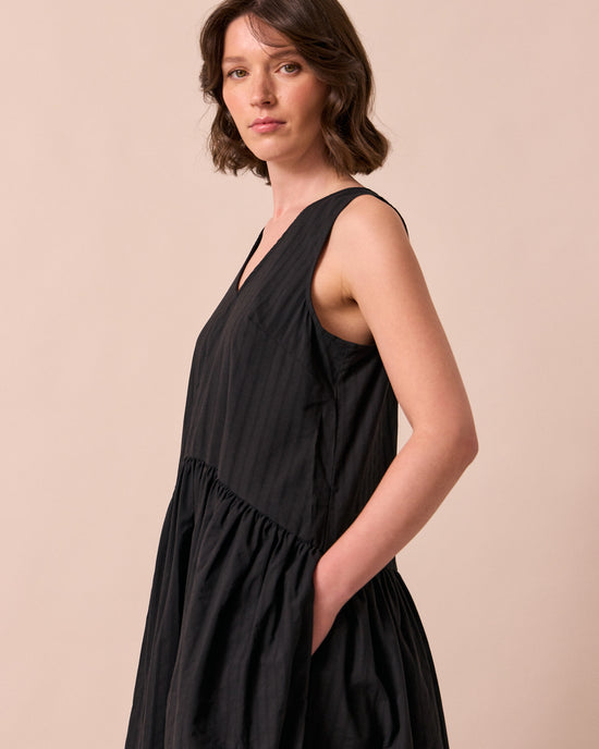 model wears zena black self stripe cotton dress