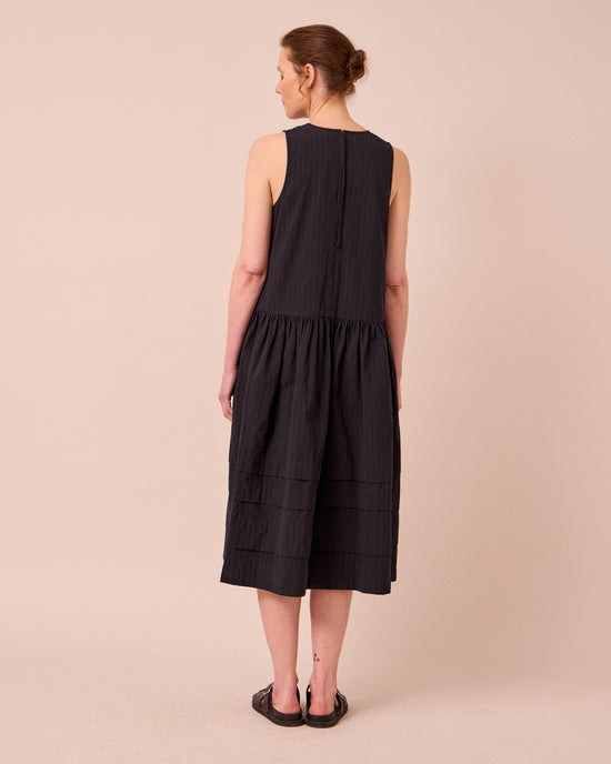 model wears zena black self stripe cotton dress
