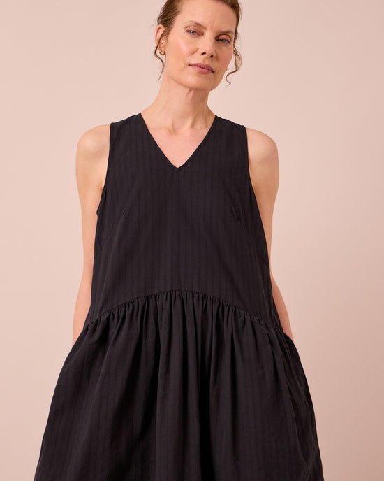 model wears zena black self stripe cotton dress