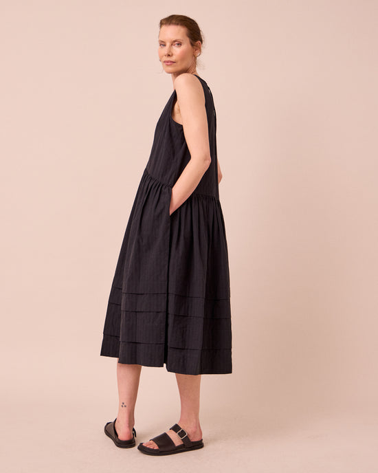 model wears zena black self stripe cotton dress