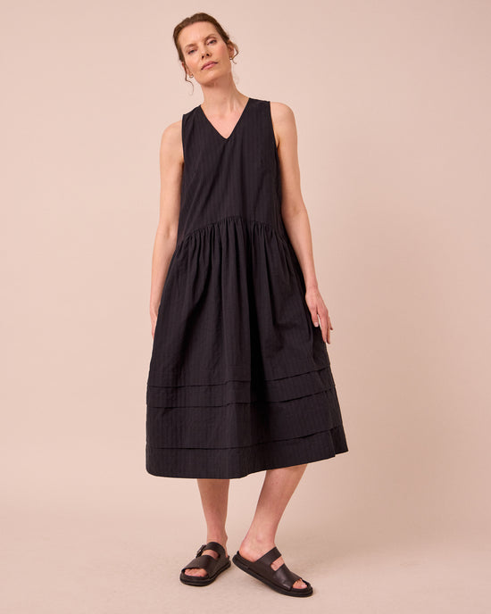 model wears zena black self stripe cotton dress