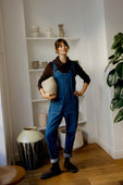 model wears lola mid blue denim jumpsuit
