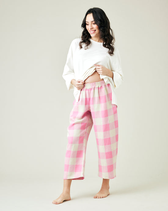 pregnant model wears pinks and ecru mega check ultimate pj linen trousers