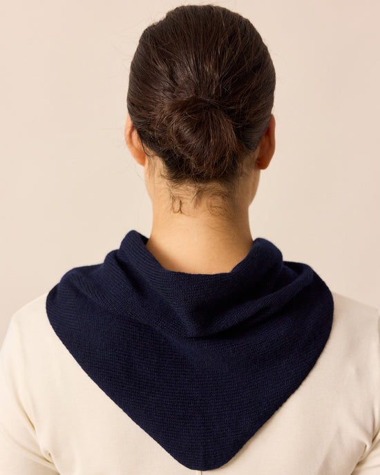 model wears navy knitted neckerchief