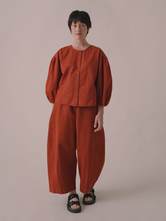model wears miley top and mathilde trousers in paprika cotton linen 
