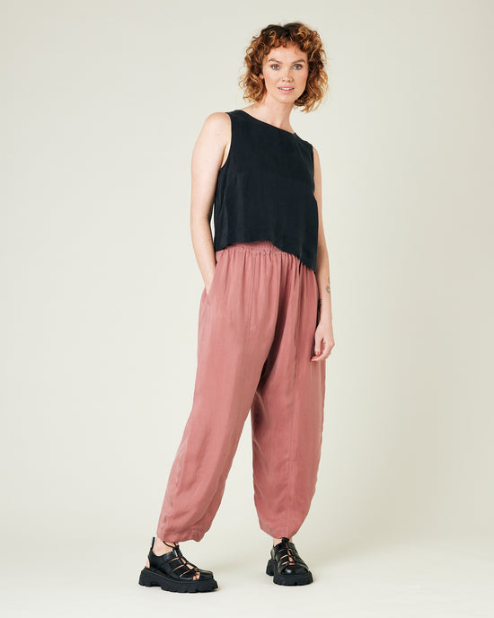 model wears dusty pink cupro trousers