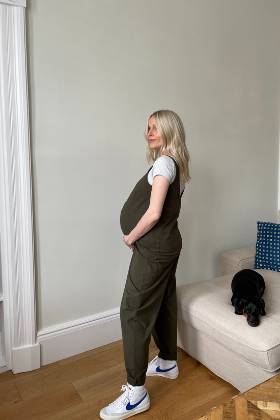 pregnant model wears olive jersey poppy jumpsuit