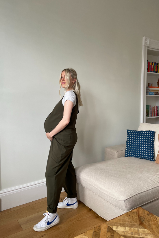 pregnant model wears olive jersey poppy jumpsuit