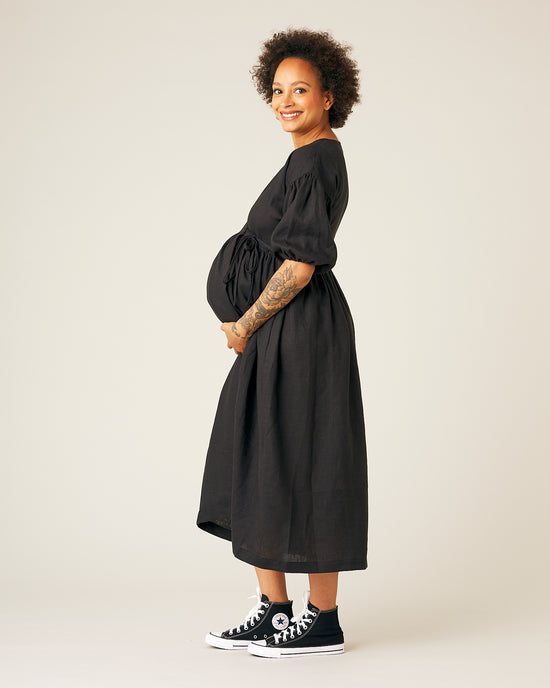 pregnant model wears black linen winnie dress