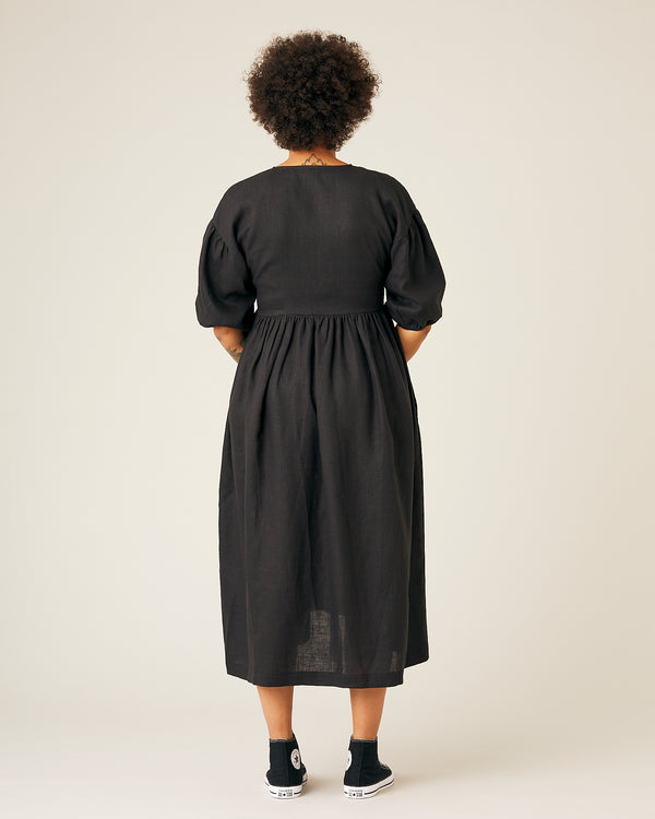 pregnant model wears black linen winnie dress