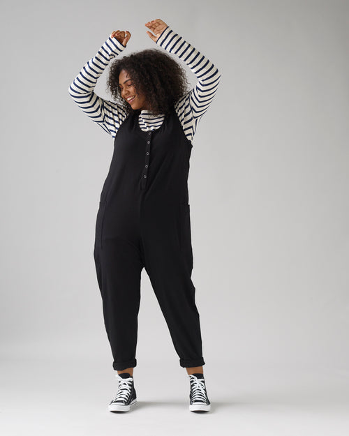 model wears black jersey poppy jumpsuit