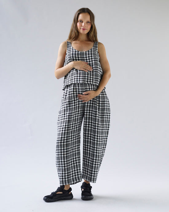 pregnant model wears mono check linen nora top