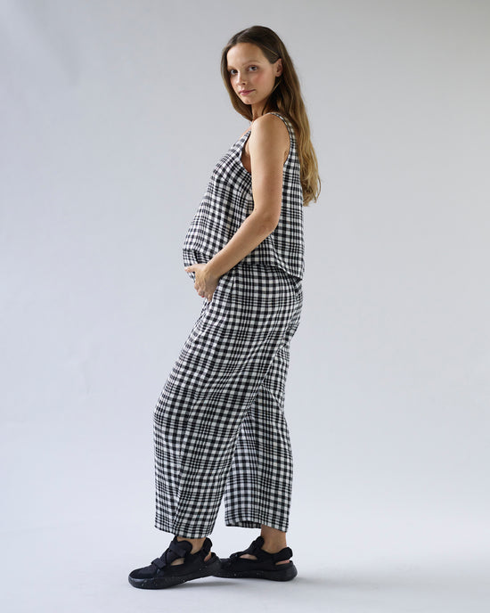 pregnant model wears mono check linen nora top