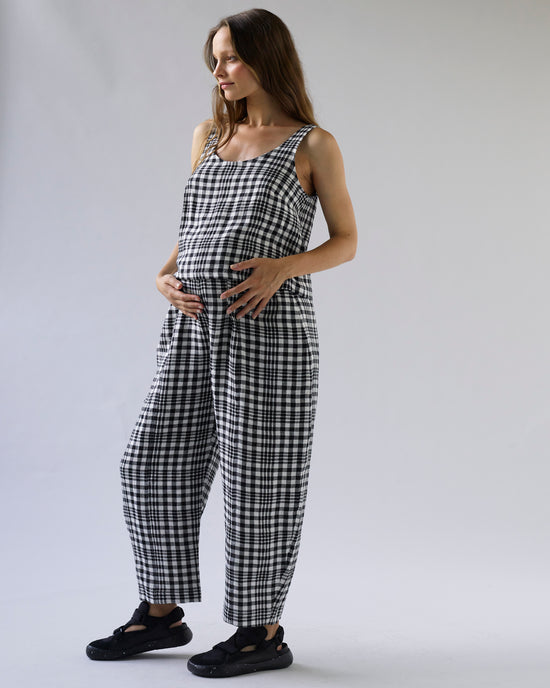 pregnant model wears mono check linen nora top