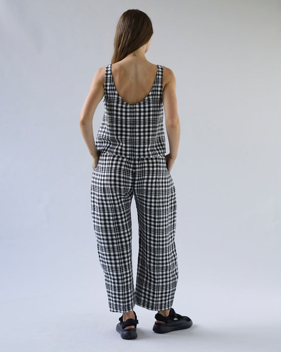 pregnant model wears mono check linen nora top