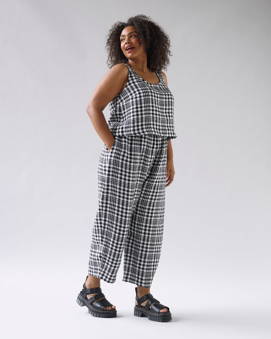 model wears mono check linen nora top