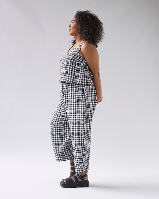 model wears mono check linen nora top