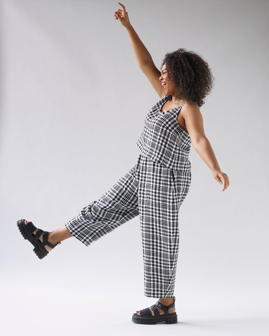 model wears mono check linen nora top