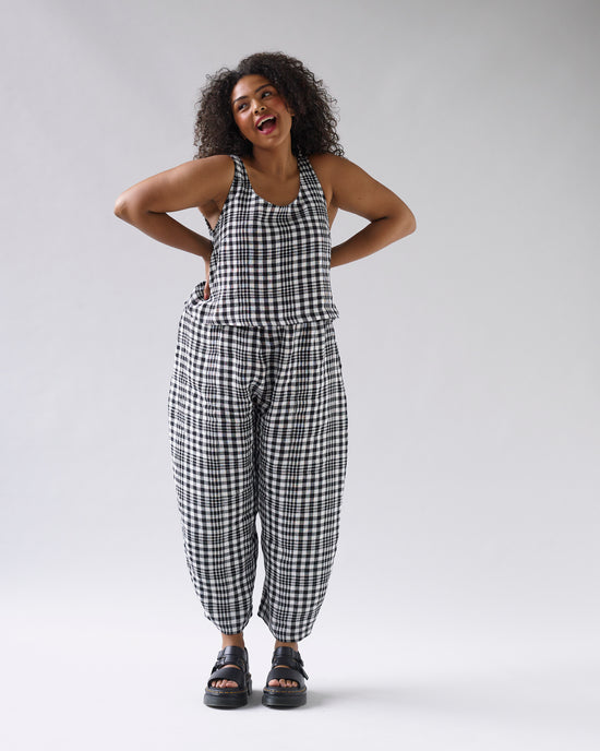 model wears mono check linen nora top