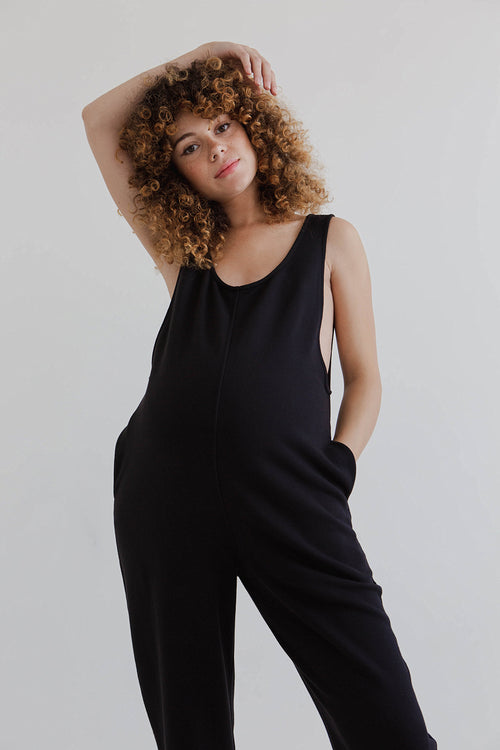 pregnant model wears black laura jumpsuit