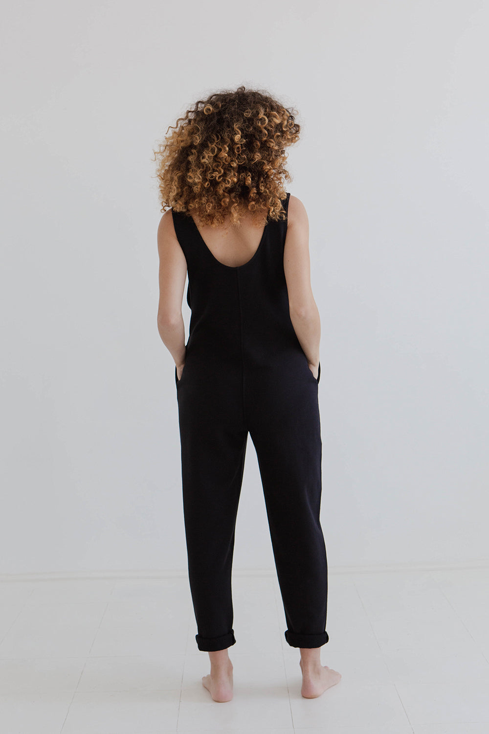 pregnant model wears black laura jumpsuit