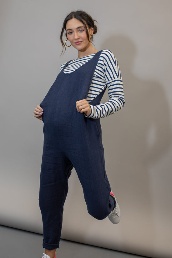 pregnant model wears navy linen laura jumpsuit