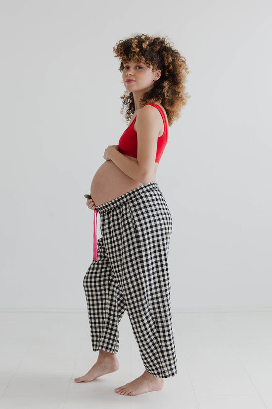 pregnant model wears black and white gingham ultimate pj linen trousers