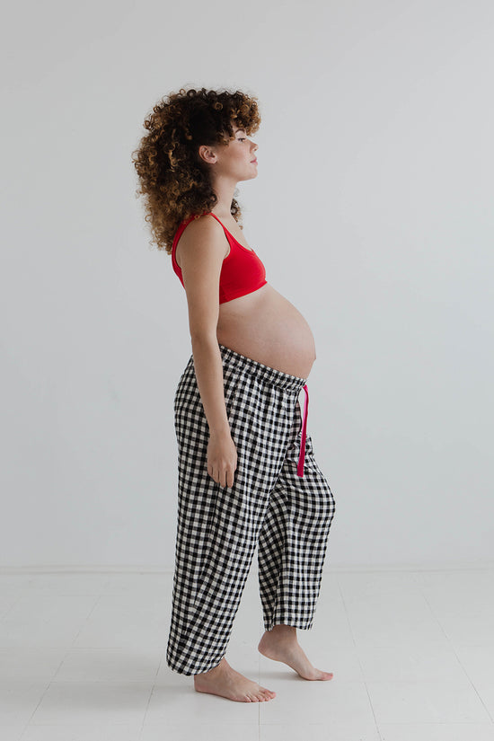 pregnant model wears black and white gingham ultimate pj linen trousers