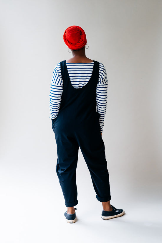 model wears black jersey poppy jumpsuit