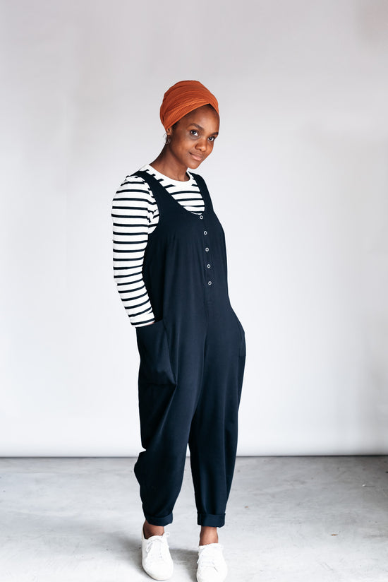 model wears black jersey poppy jumpsuit