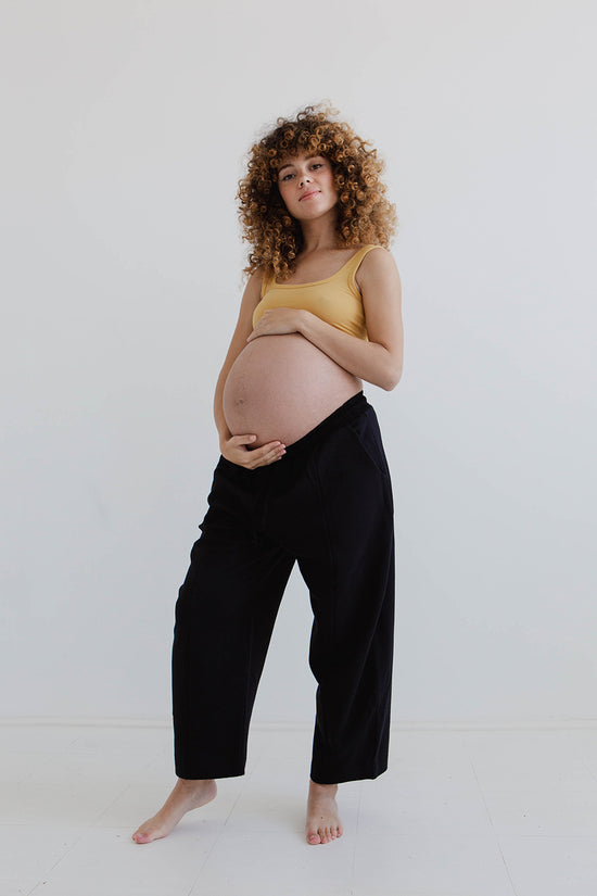 pregnant model wears black jersey jenny trousers